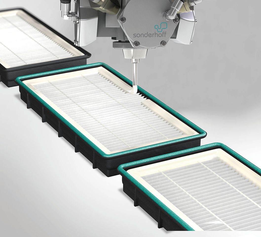The mixing head of the dosing system applies Fermadur foamed adhesive sealant along the filter frame contour for bonding and sealing pleated filters.