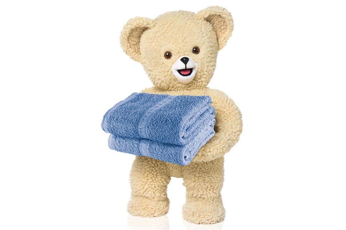The Snuggle® Bear, a teddy bear holding two folded towels