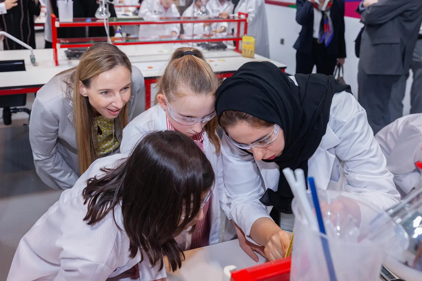 Dr. Simone Bagel-Trah, Chairwoman of the Supervisory Board and the Shareholders’ Committee of Henkel, watching kids while conducting experiments